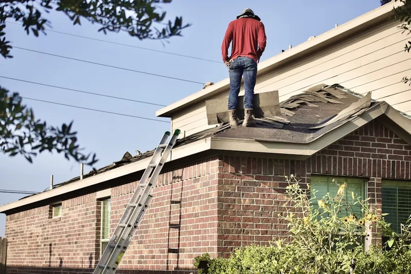 Professional roofer working on a residential roof in Orient